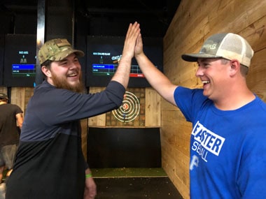 bachelor and best men at axe throwing party